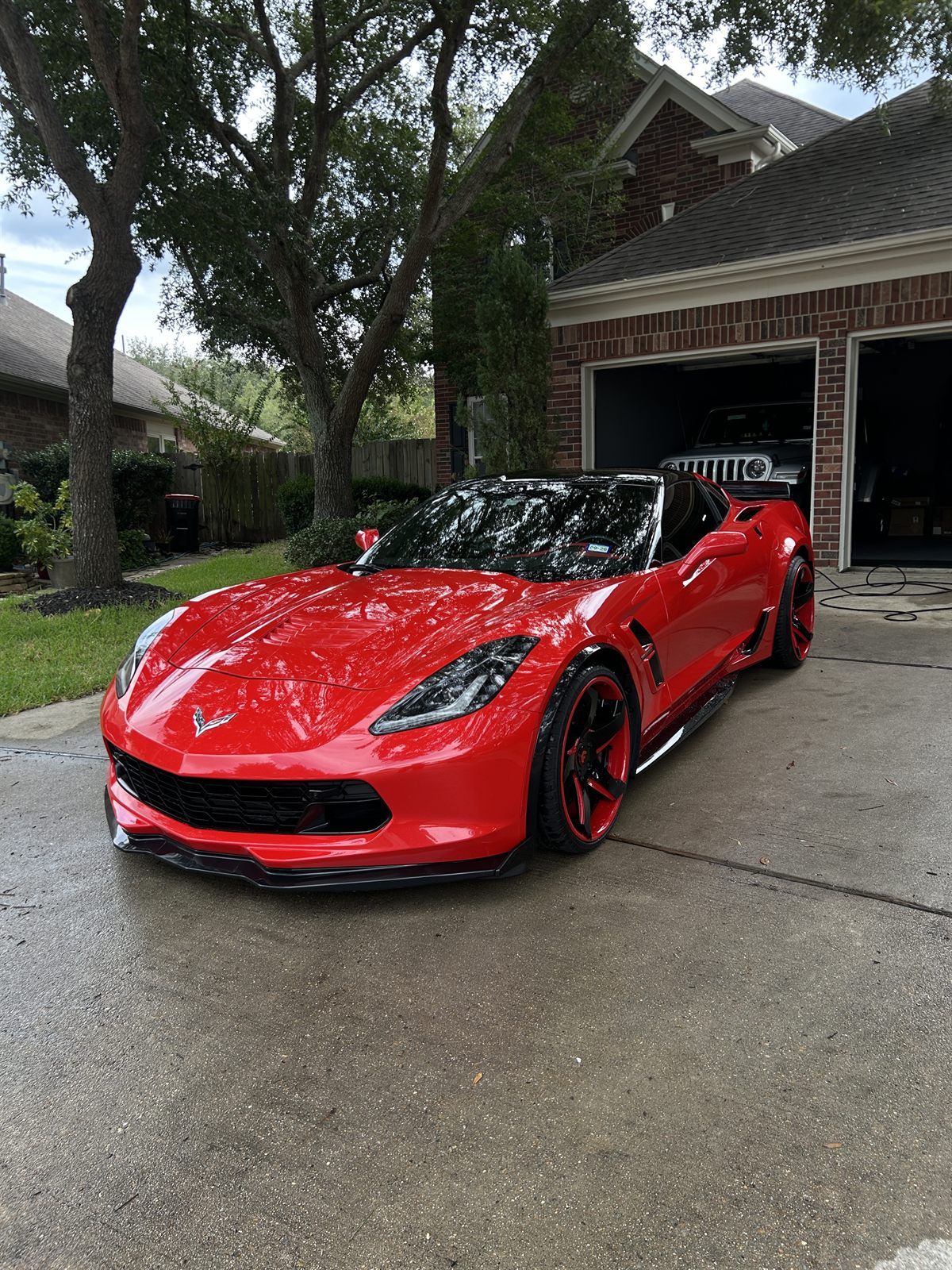 Red Chevrolet Corvette after a full exterior detail in a Katy, TX driveway
