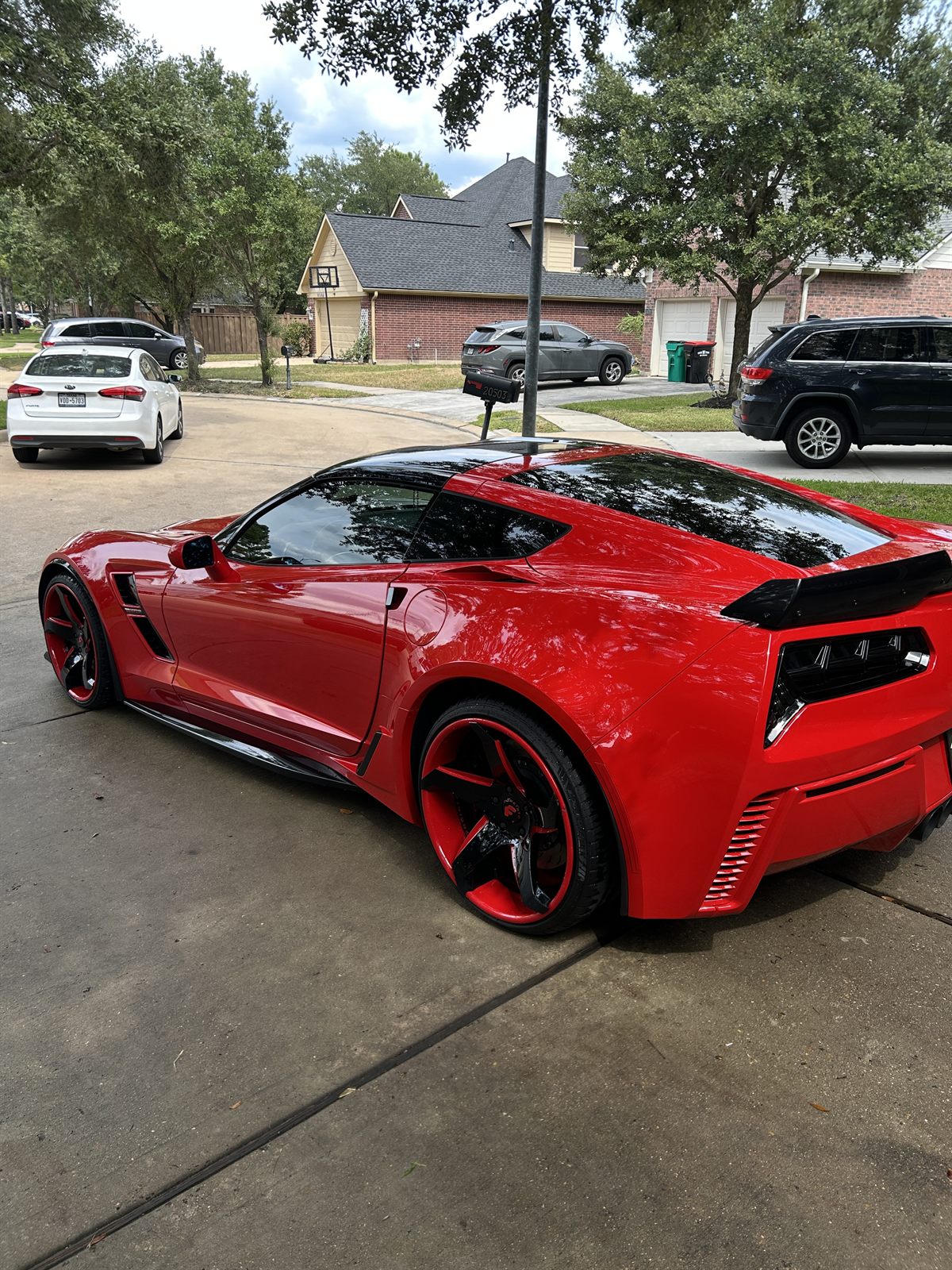 Red Chevrolet Corvette rear three-quarter view after a full exterior detail